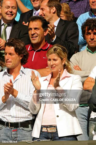 Miroslava Vavrinec, girlfriend of Switzerland's Roger Federer, applauds as Roger Federer defeated Rafael Nadal of Spain in Men's singles final of the...