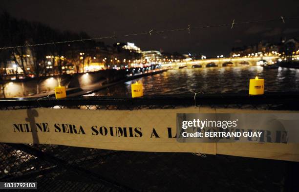 View taken on December 10, 2008 in Paris shows a banner reading: "Nobody will be submitted to torture" during a rally organized by Amnesty...