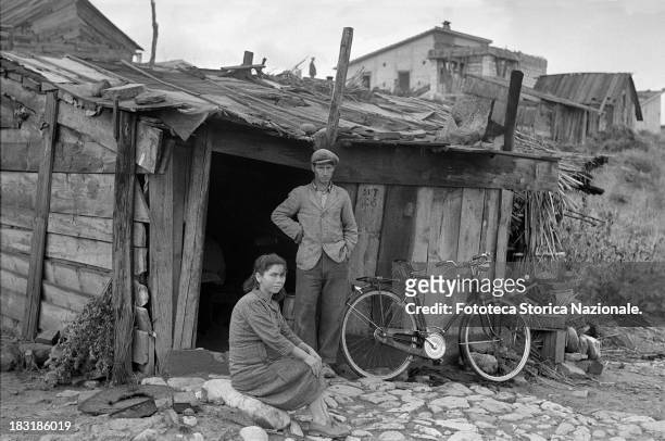 Residents of a shantytown built by the workers of a new Montecatini facility, on a lot set aside by the company , for this purpose, circa 1950. From...
