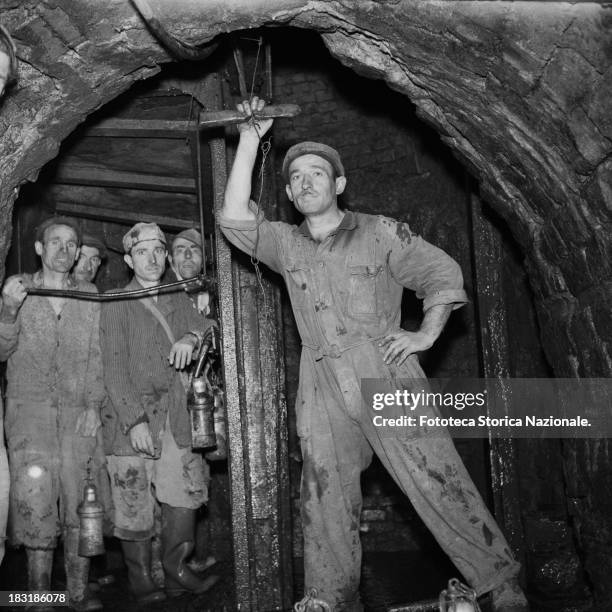 The workers operate levers in the ancient lignite mine called 'Lunara', because of its location near Luni, La Spezia, Italy, 1953. The mine was...