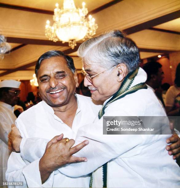 Bhartiya Janta Party leader and Union Minister for Human Resources Development Murli Manohar Joshi hugs opposition Samajwadi Party leader Mulayam...