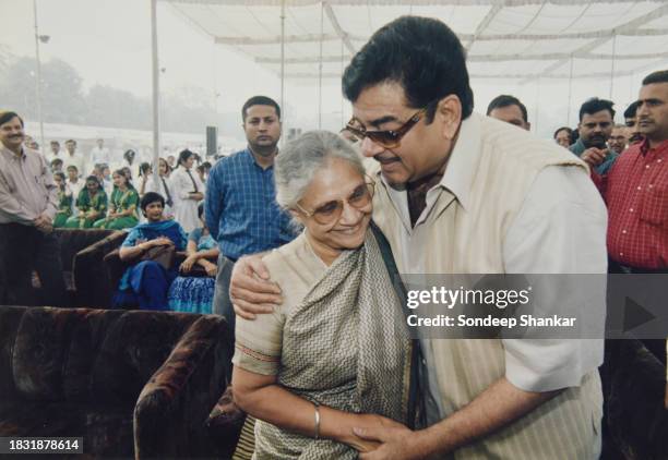 Bollywood actor turned Union Health Minister Shatrughan Sinha hugs Delhi Chief Minister Sheila Dikshit at the inauguration of a health mela for...