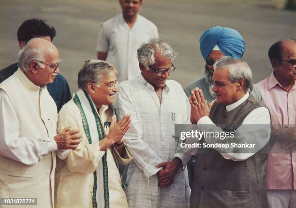 Prime Minister Atal Bihari Vajpayee greets Ministers L.K. Advani , Murli Manohar Joshi , and George Fernandes at Delhi airport before boarding a...