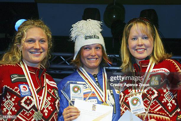 Brigitte Acton of Canada, 2nd place, Julia Mancuso of USA, 1st place and Kelly Vanderbeek of Canada, 3rd place celebrate with their medals after the...