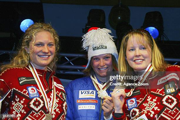 Brigitte Acton of Canada, 2nd place, Julia Mancuso of USA, 1st place and Kelly Vanderbeek of Canada, 3rd place celebrate with their medals after the...