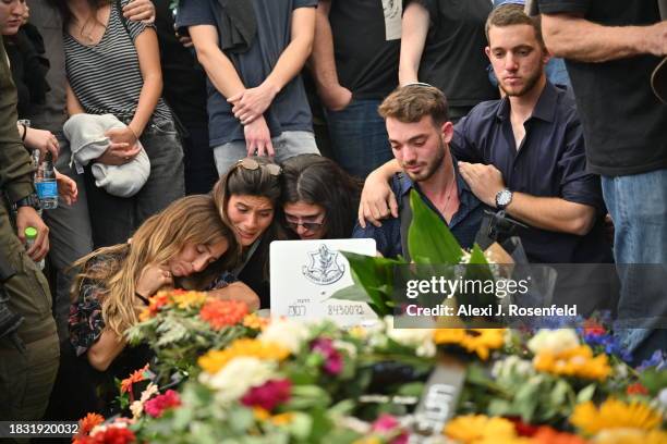 Family and friends grieve for First Sergeant Major Gal Meir Eisenkot at the burial site during his funeral in the Herzliya cemetery on December 8,...