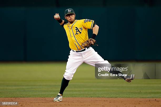 Eric Sogard of the Oakland Athletics throws out Victor Martinez of the Detroit Tigers in the second inning during Game Two of the American League...