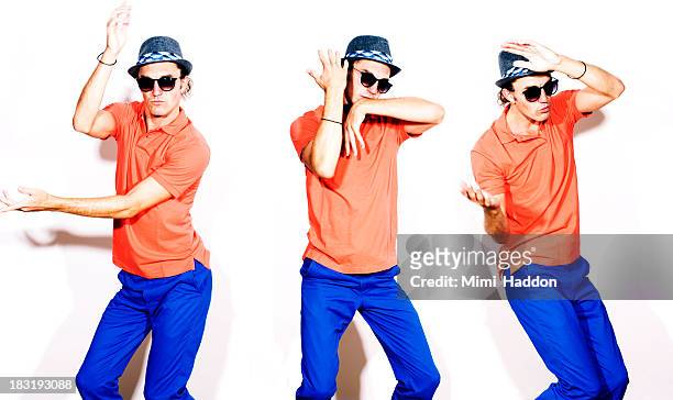young hip man dancing on white background - multiple images of the same person stock pictures, royalty-free photos & images