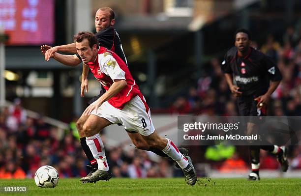 Fredrik Ljungberg of Arsenal takes the ball past Claus Jensen of Charlton Athletic during the FA Barclaycard Premiership match held on March 2, 2003...