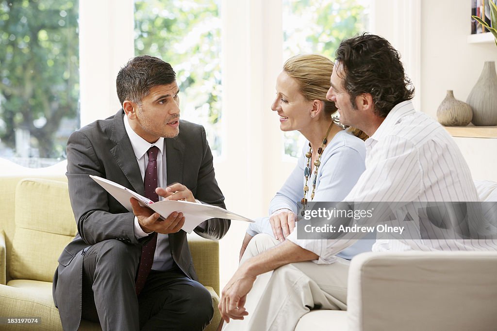 Salesman talking to a middle aged couple