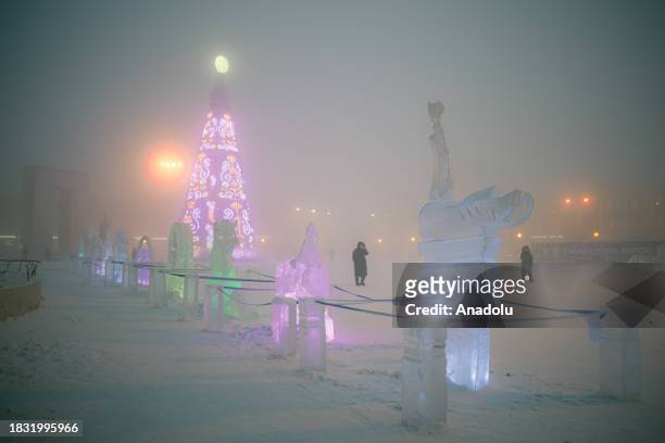 View of the street covered with snow and ice and Christmas decorations as cold weather conditions negatively affect daily life in Yakutsk, the...
