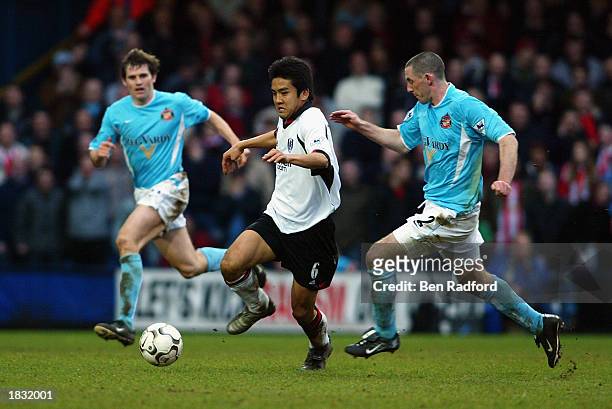 Junichi Inamoto of Fulham takes the ball past Kevin Kilbane and Stephen Wright of Sunderland during the FA Barclaycard Premiership match held on...