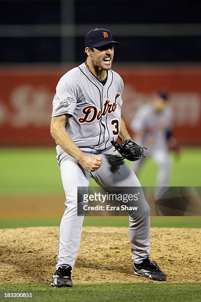 Justin Verlander of the Detroit Tigers reacts after striking out Stephen Vogt of the Oakland Athletics to end the seventh inning during Game Two of...