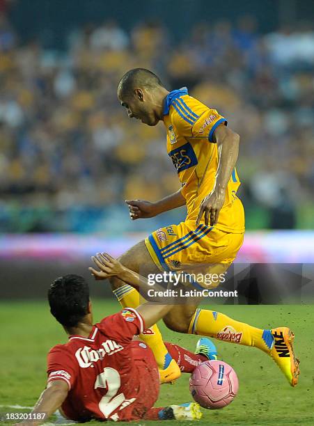 Guido Pizarro of Tigres fights for the ball with Francisco Gamboa of Toluca during a match between Tigres UANL and Toluca as part of the Apertura...