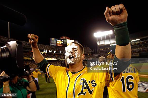 Stephen Vogt of the Oakland Athletics gets a pie in the face by teammate Josh Reddick after scoring the game winning single against Al Alburquerque...