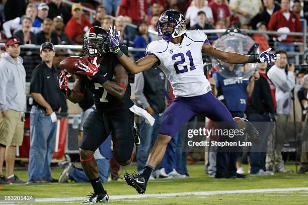 Wide receiver Ty Montgomery of the Stanford Cardinal catches the ball for a touchdown as defensive back Marcus Peters of the Washington Huskies...