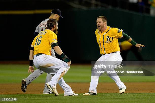 Stephen Vogt of the Oakland Athletics celebrates with his teammate Josh Reddick after defeating the Detroit Tigers in Game Two of the American League...