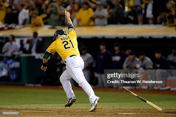 Stephen Vogt of the Oakland Athletics celebrates after scoring the game winning single against Al Alburquerque of the Detroit Tigers in the ninth...