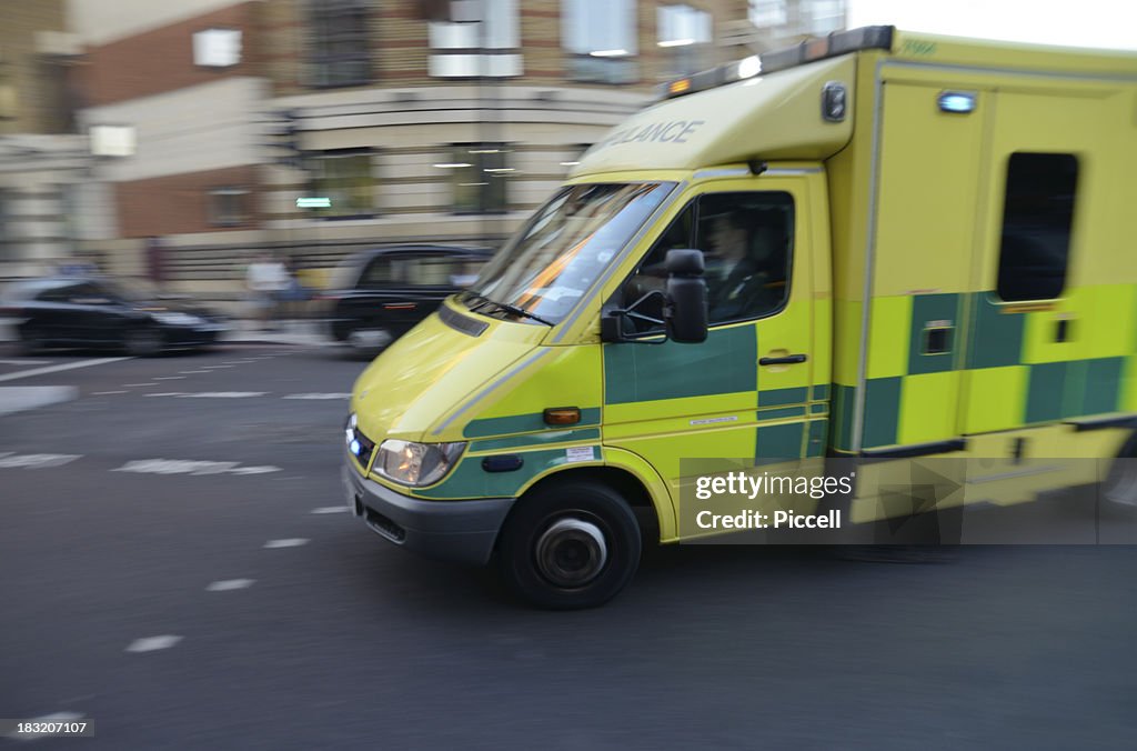 London ambulance on signal turning street corner