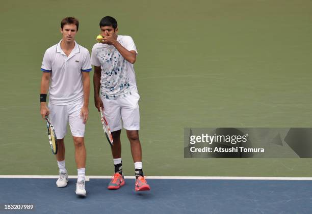 Rohan Bopanna of India and Edouard Roger-Vasselin of France talk during men's doubles final match against Jamie Murray of Great Britain and John...