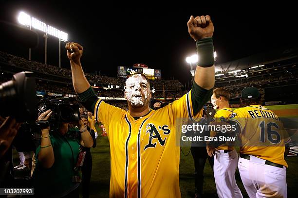 Stephen Vogt of the Oakland Athletics gets a pie in the face by teammate Josh Reddick after scoring the game winning single against Al Alburquerque...