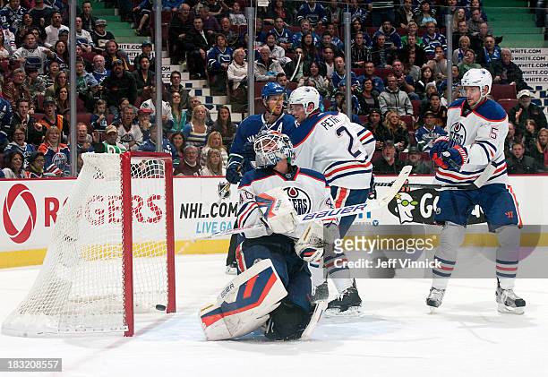 Devan Dubnyk of the Edmonton Oilers looks back as the puck crosses the line for a goal by the Vancouver Canucks during their NHL game at Rogers Arena...