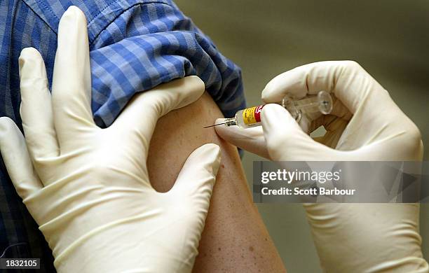 Patient is vaccinated against contagious diseases March 6, 2003 in London. The British Government has said it will not inoculate the public against...