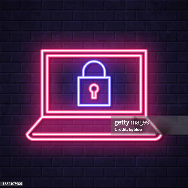 laptop with padlock. glowing neon icon on brick wall background - security wall stock illustrations