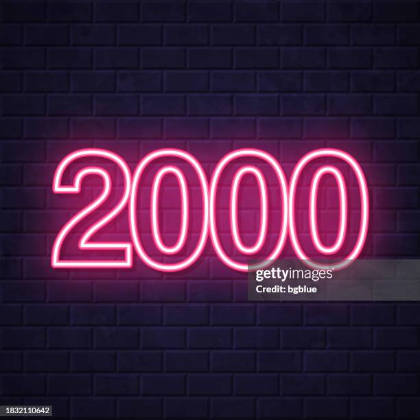2000 - two thousand. glowing neon icon on brick wall background - 2000 stock illustrations