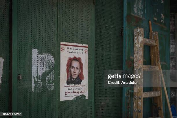 Photos of some Palestinians killed by Israeli forces are hung on a wall as Palestinians at Aida Refugee Camp living their daily lives in fear due to...