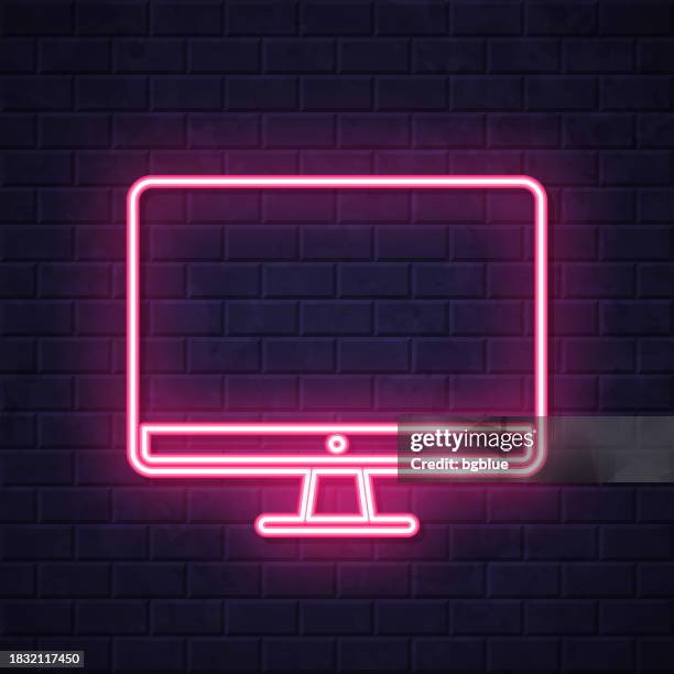 desktop computer. glowing neon icon on brick wall background - flat tv wall stock illustrations