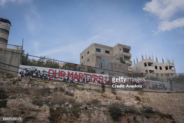 Slogan written on the border wall is seen as Palestinians at Aida Refugee Camp living their daily lives in fear due to the attacks by Israeli forces...