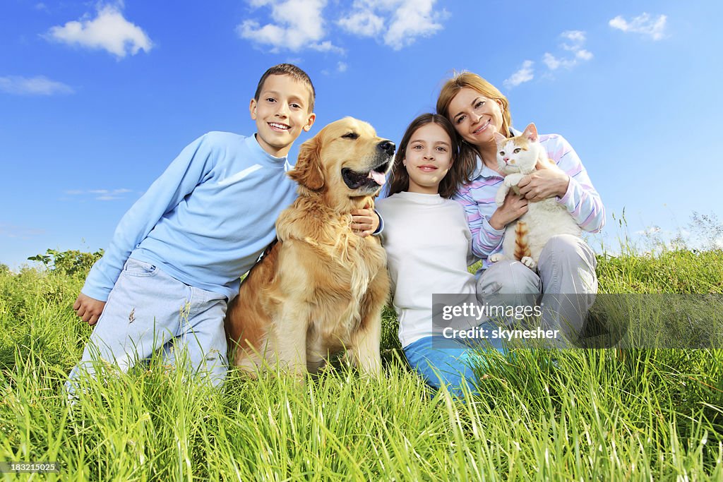 Portrait of happy family with cat and dog.