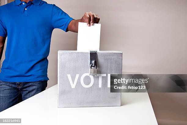african descent man casting his vote. ballot box. - election box stock pictures, royalty-free photos & images