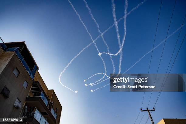 Contrails of Israeli Iron Dome anti-missile defense system strike Hamas rockets overhead as Hamas militants in Gaza continue fire into Israel,...