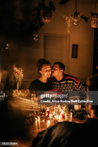 couple exchanging presents at a dinner party - exchanging gifts stock pictures, royalty-free photos & images