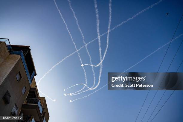 Contrails of Israeli Iron Dome anti-missile defense system strike Hamas rockets overhead as Hamas militants in Gaza continue fire into Israel,...