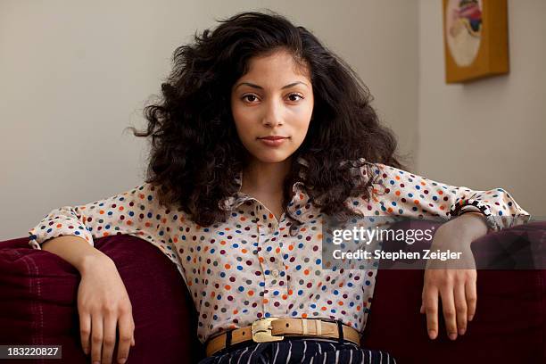 portrait of young hispanic woman - sitting on couch imagens e fotografias de stock
