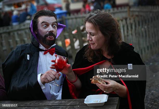 Vampire couple enjoy a drink and a burger at the Shocktober Fest at Tulleys Farm on October 5, 2013 near Crawley, West Sussex. Each October thousands...