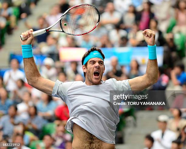 Juan Martin Del Potro of Argentina reacts with joy to celebrate his victory over Milos Raonic of Canada during their final match of the Japan Open...