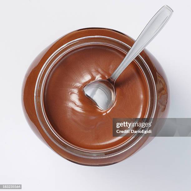 jar of chocolate cream on white background with spoon inside - nutella stock pictures, royalty-free photos & images