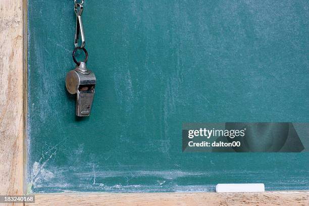 a metallic whistle hanging by the chalkboard - whistle blackboard stock pictures, royalty-free photos & images