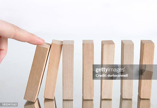 domino effect, going down - dominoes stock pictures, royalty-free photos & images