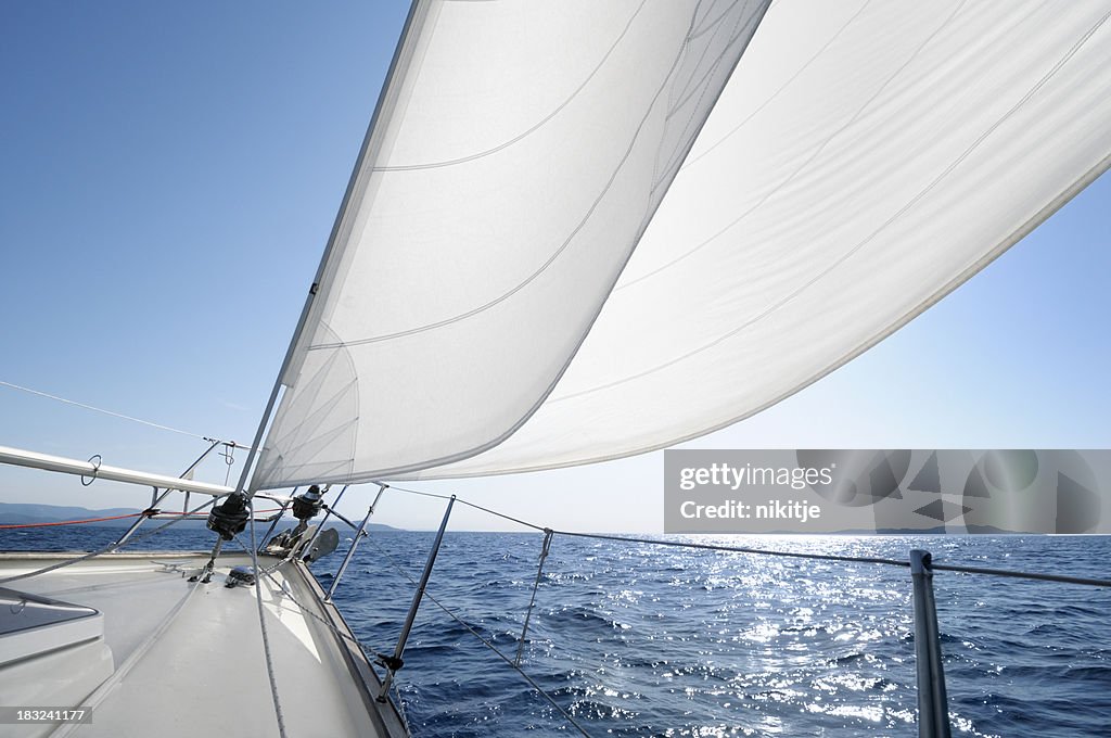 Sailing towards the horizon on a sunny day