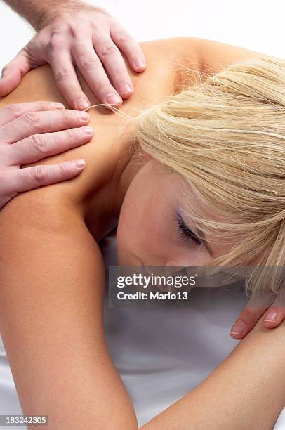 beatiful girl receiving a massage - remedial massage stock pictures, royalty-free photos & images