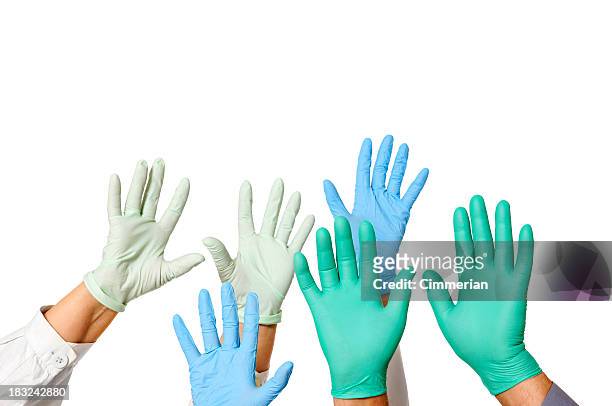hands with doctor rubber gloves in green, blue, and white - surgical glove stock pictures, royalty-free photos & images