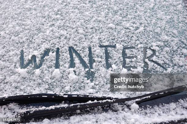 winter written on a snow covered window - vindrutetorkare bildbanksfoton och bilder