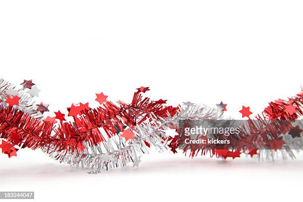 red and silver tinsel with stars, isolated - red tinsel stock pictures, royalty-free photos & images