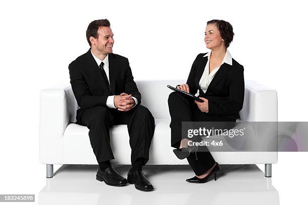 businesswoman interviewing man on a couch - couch interview stock pictures, royalty-free photos & images