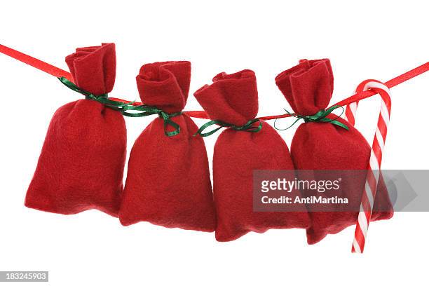 red christmas bags for advent calendar on a string - adventkalender stock pictures, royalty-free photos & images